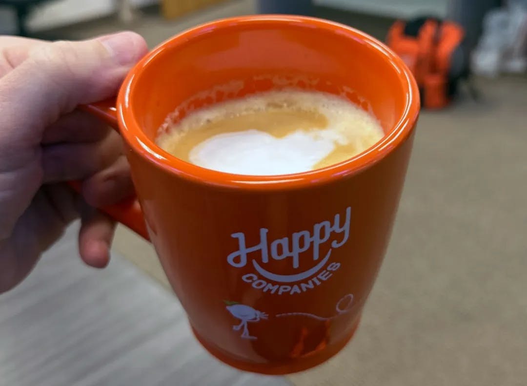 Orange coffee cup of Happy Companies