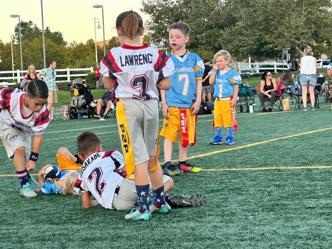 Image of a group of kids on a flag football field