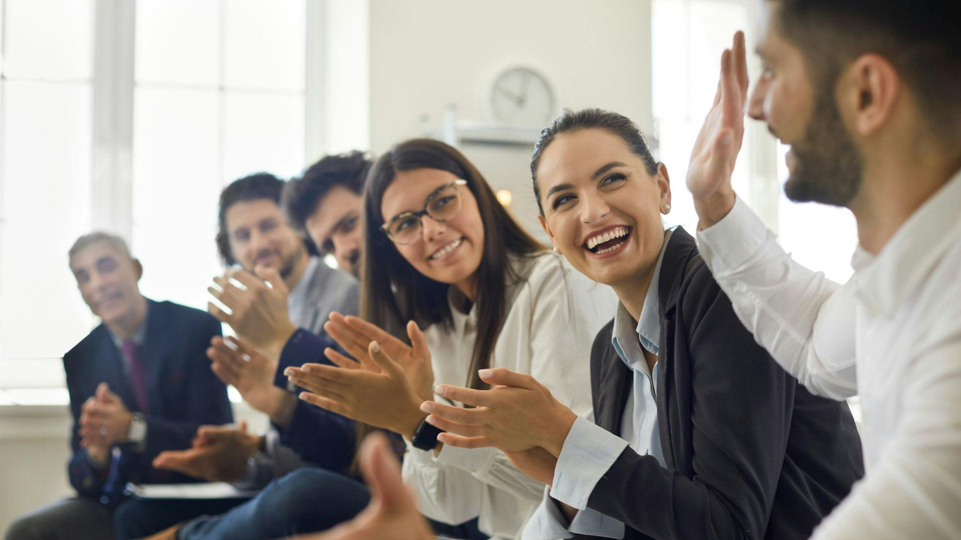 Employees receiving recognition at a company event, highlighting the importance of appreciation in fostering a positive workplace culture.