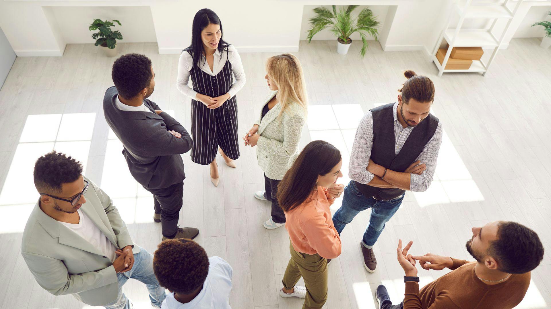 A diverse group of individuals forming a circle, engaged in a discussion or activity together.