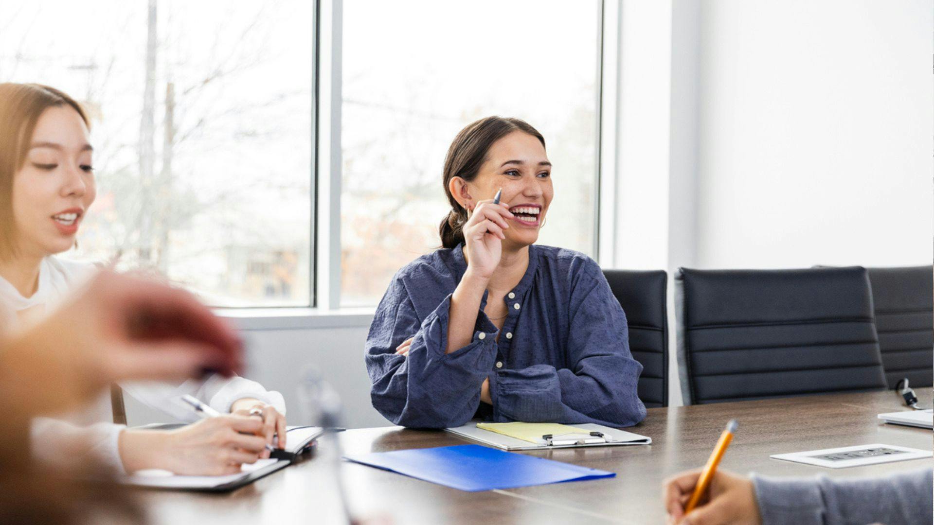 A team of employees gathered around a conference table for a discussion.