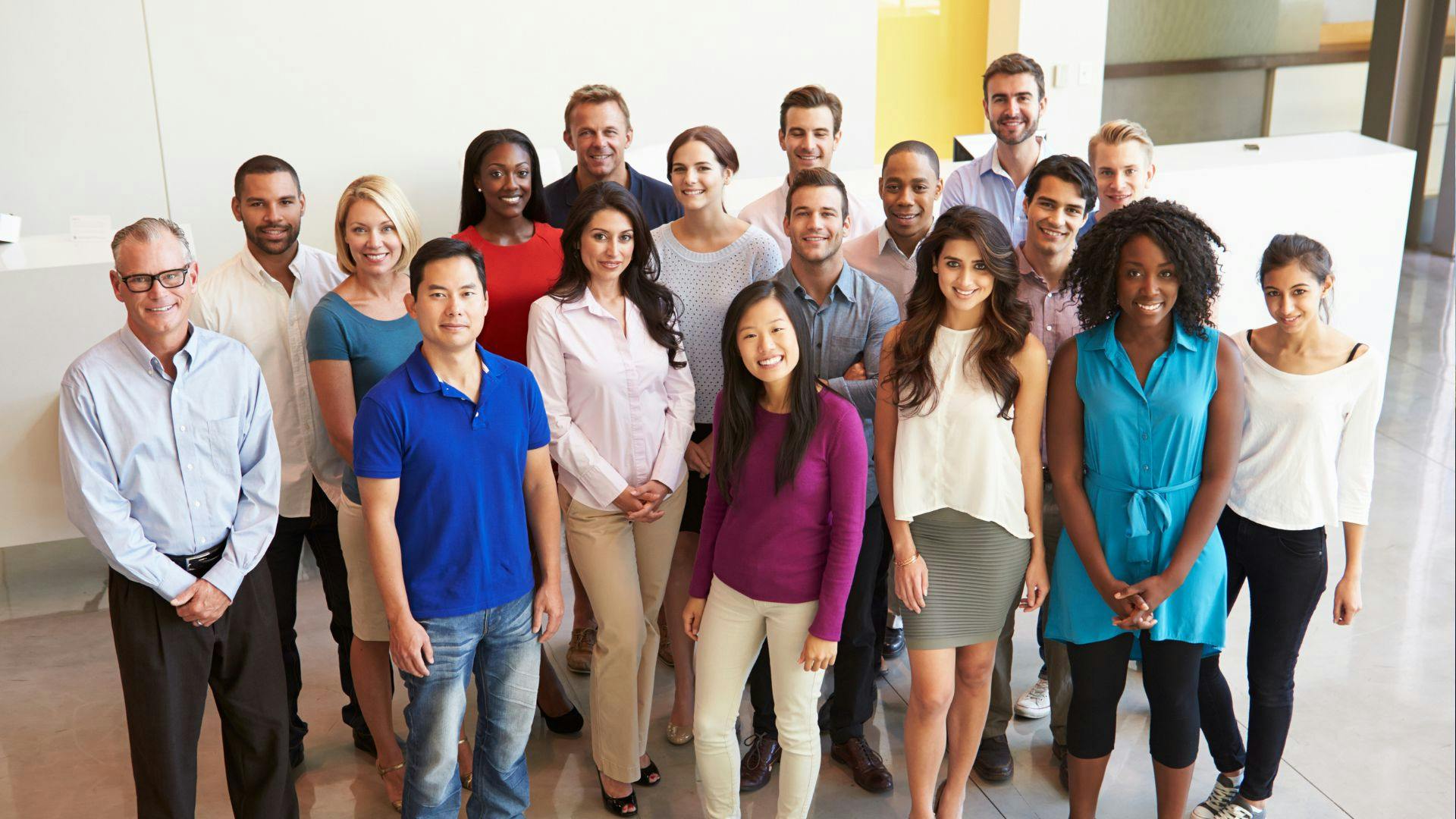 Team of coworkers gathered in a contemporary office environment.