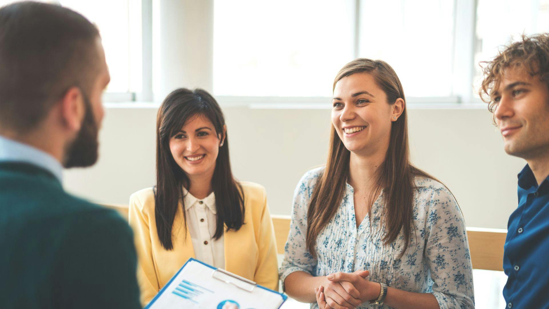 Colleagues conversing in an office environment, fostering communication and teamwork in a professional atmosphere.